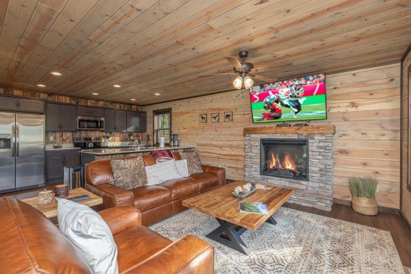 Living room with fireplace & TV at Heaven's Hill, a 3 bedroom cabin rental located in Gatlinburg