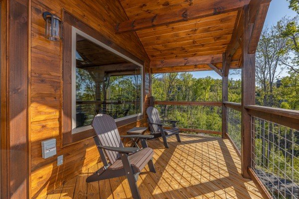 Adirondack chairs on the upper deck at Heaven's Hill, a 3 bedroom cabin rental located in Gatlinburg