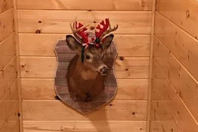 Deer with Christmas decor at Wet Feet Retreat, a 5 bedroom cabin rental located in Pigeon Forge