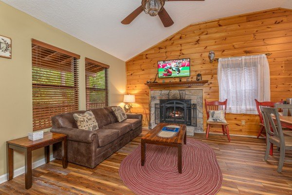 Living room seating and fireplace at Copper Owl, a 2 bedroom cabin rental located in Pigeon Forge
