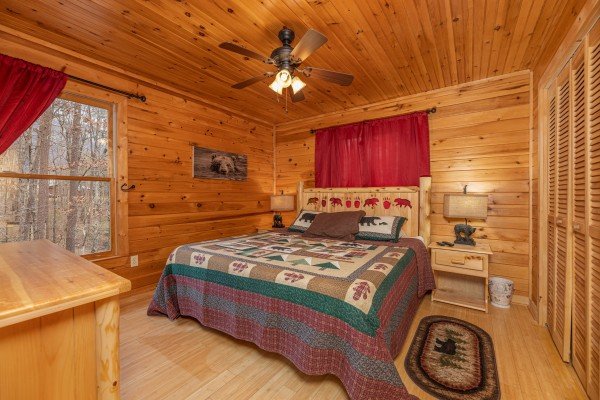 Bedroom with a king bed, night stands, and lamps at Cabin Life, a 2 bedroom cabin rental located in Pigeon Forge