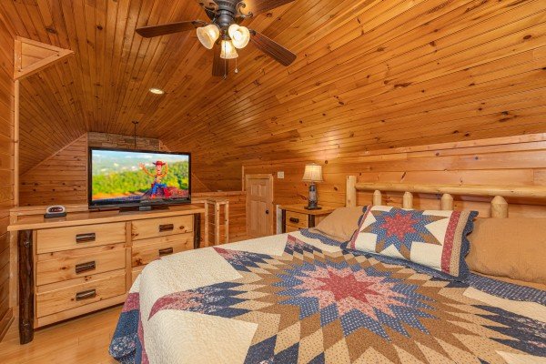 King bed, dresser, and TV in the loft bedroom at Cabin Life, a 2 bedroom cabin rental located in Pigeon Forge