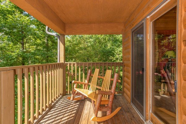 Loveseat rocker on the covered deck at Cabin Life, a 2-bedroom cabin rental located in Pigeon Forge