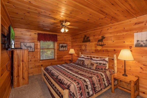 Bedroom with a king-sized log bed at Hibernation Station, a 3-bedroom cabin rental located in Pigeon Forge