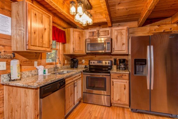 Kitchen with stainless appliances at Cupid's Crossing, a 1 bedroom cabin rental located in Pigeon Forge