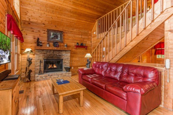 Sofa in the living room at Cupid's Crossing, a 1 bedroom cabin rental located in Pigeon Forge