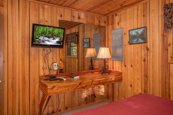 A built in console and flat screen television at Apple View, a 2 bedroom cabin rental located in Pigeon Forge
