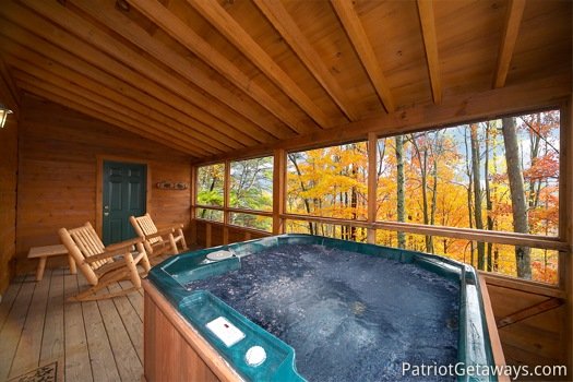 Hot tub in screened in deck at Hooked on Bears, a 2 bedroom cabin rental located in Pigeon Forge
