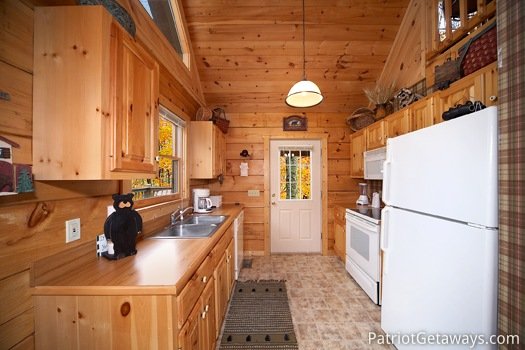 Kitchen with white appliances at Hooked on Bears, a 2 bedroom cabin rental located in Pigeon Forge
