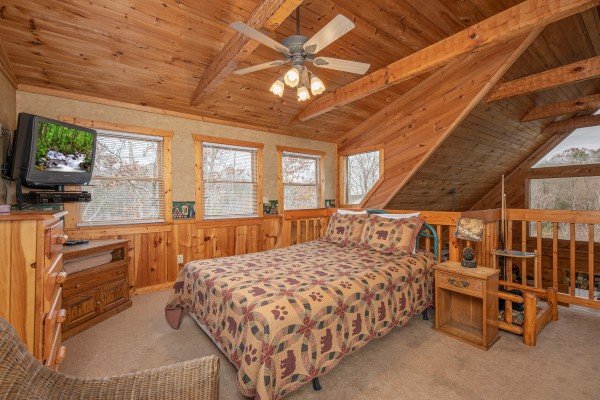 Loft bedroom with bed, night stands, and TV at Hooked on Bears, a 2 bedroom cabin rental located in Pigeon Forge