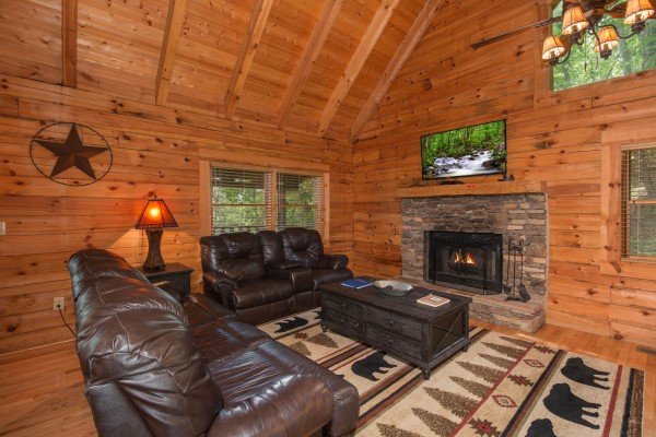 Living room with fireplace and TV at Bear Mountain, a 2 bedroom cabin rental located in Pigeon Forge