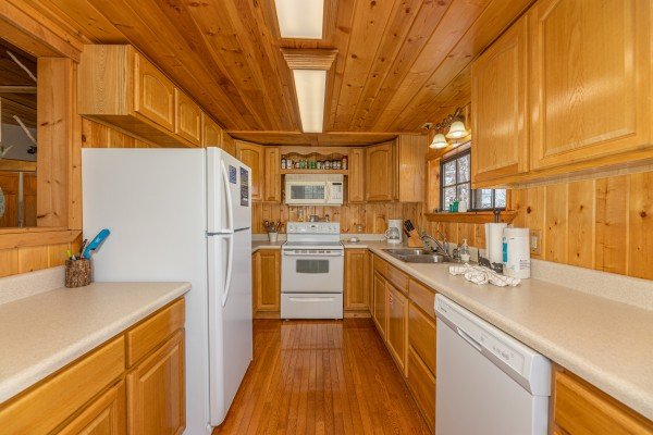 Kitchen with white appliances at A Mountain Hyde-a Way, a 2 bedroom cabin rental located in Pigeon Forge