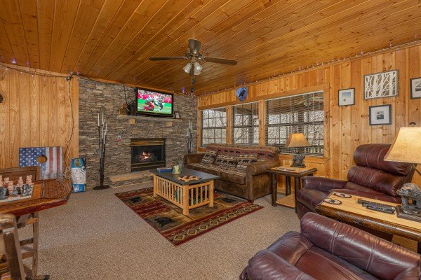 Living room with fireplace and tv at A Mountain Hyde-a Way, a 2 bedroom cabin rental located in Pigeon Forge