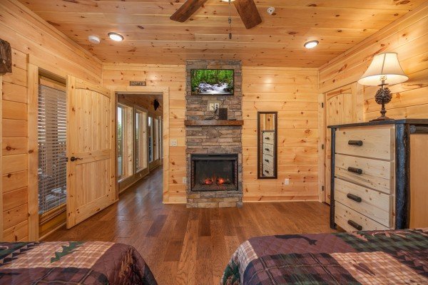 Fireplace and TV in a bedroom at Elk Horn Lodge, a 5 bedroom cabin rental located in Gatlinburg