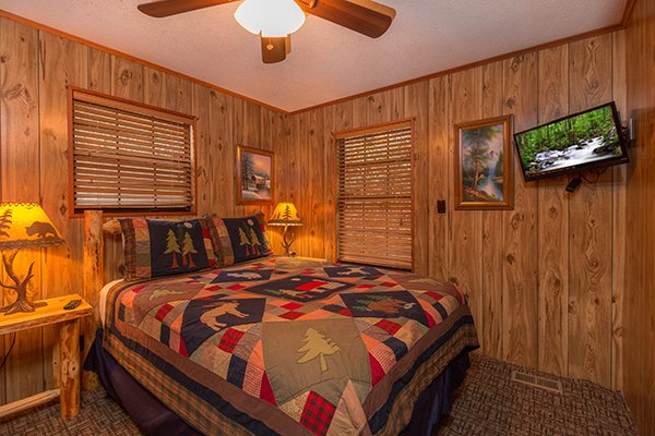 Queen bedroom with two nightstands and a TV at Up the Creek, a 4 bedroom cabin rental located in Gatlinburg