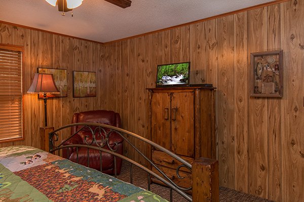 Chair, armoire and TV in a bedroom at Up the Creek, a 4 bedroom cabin rental located in Gatlinburg