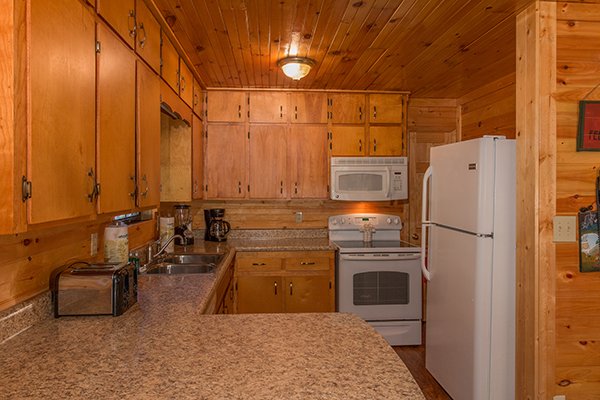Kitchen with white appliances at Up the Creek, a 4 bedroom cabin rental located in Gatlinburg
