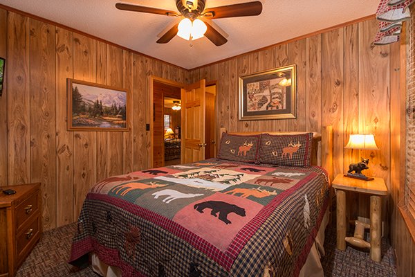 Queen bed and a nightstand at Up the Creek, a 4 bedroom cabin rental located in Gatlinburg