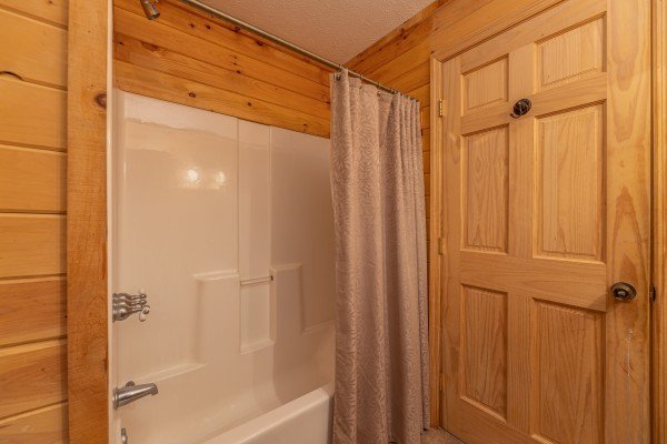Tub and shower at Wild at Heart, a 1 bedroom cabin rental located in Gatlinburg