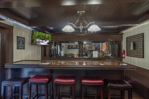 Wet bar with a TV on the lower floor at Best View Ever! A 5 bedroom cabin rental in Pigeon Forge