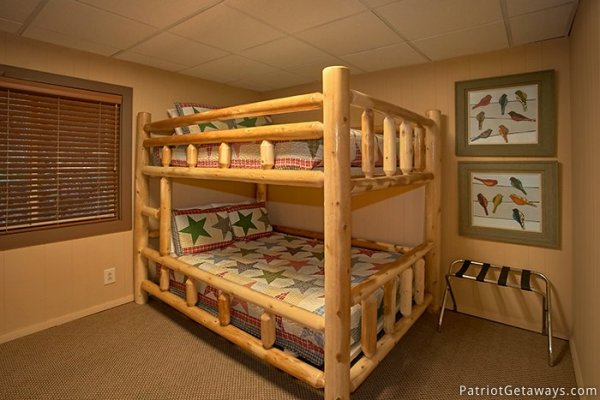 Full sized bunk beds on a custom log frame at Gatlinburg Lodge, a 6-bedroom cabin rental located in Gatlinburg