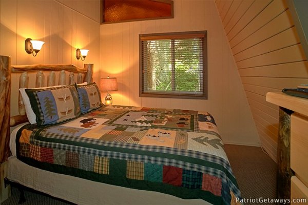 Custom log framed bed at Gatlinburg Lodge, a 6-bedroom cabin rental located in Gatlinburg