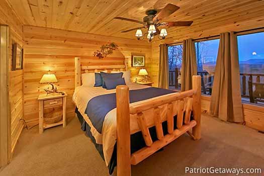 Queen log post bed on main floor of Gone to Therapy, a 2-bedroom cabin rental located in Gatlinburg