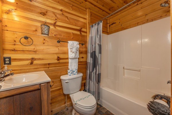 Tub and shower in a bathroom at A Bear on the Ridge, a 2 bedroom cabin rental located in Pigeon Forge