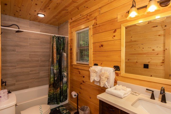 Bathroom with a tub and shower at Paws on the Porch, a 2 bedroom cabin rental located in Gatlinburg