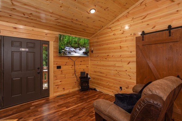 Living room with TV and sofa at Paws on the Porch, a 2 bedroom cabin rental located in Gatlinburg