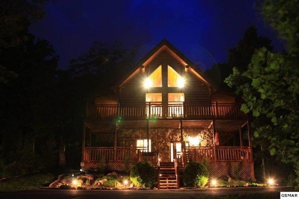 Rising Wolf Lodge, a 3 bedroom cabin rental located in Pigeon Forge, lit at night