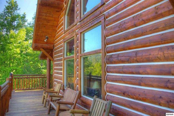 Log furniture on the deck at Rising Wolf Lodge, a 3 bedroom cabin rental located in Pigeon Forge