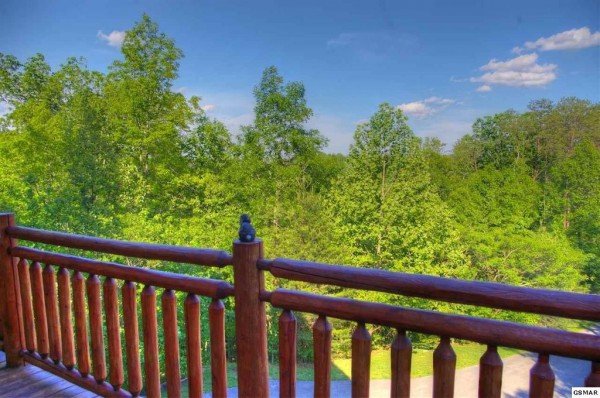 Looking out onto the trees at Rising Wolf Lodge, a 3 bedroom cabin rental located in Pigeon Forge