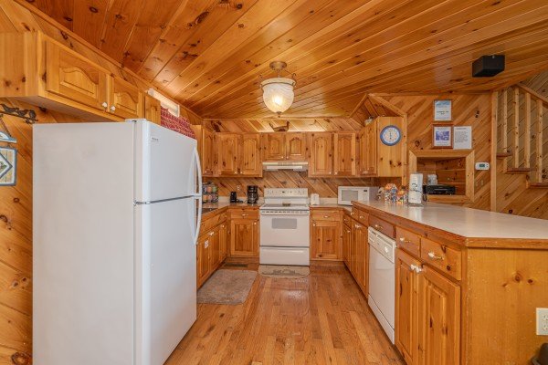 Kitchen with white appliances at Kaleidoscope, a 2 bedroom cabin rental located in Pigeon Forge