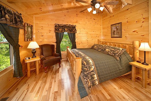 Bedroom with king-sized bed on a log frame at Big Bear Cub House, a 1-bedroom cabin rental located in Gatlinburg
