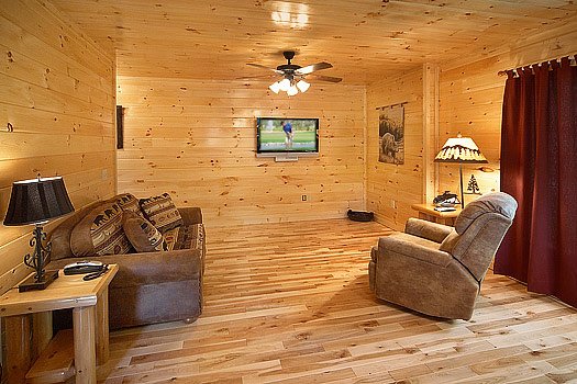 Family room on side of game room with love seat and recliner at Big Bear Cub House, a 1-bedroom cabin rental located in Gatlinburg