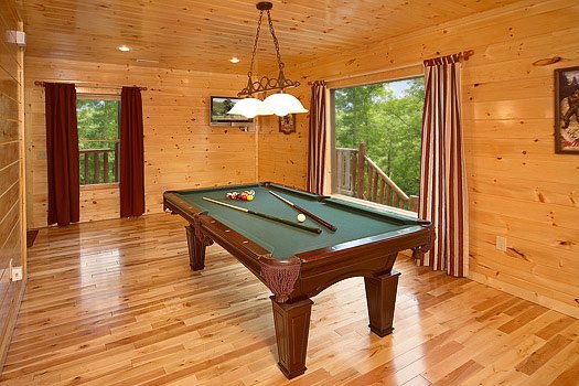 Green felted pool table in the game room at Big Bear Cub House, a 1-bedroom rental located in Gatlinburg