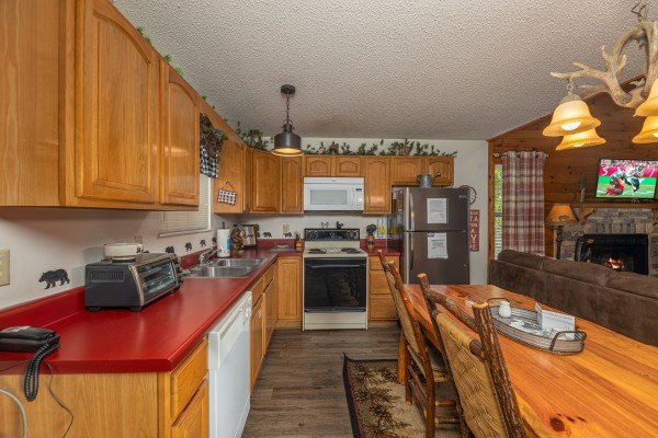 Kitchen with dining table at Magic Moments, a 2 bedroom cabin rental located in Pigeon Forge