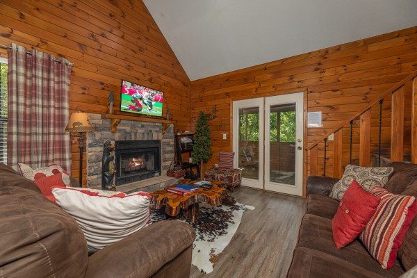 Living room with fireplace and TV at Magic Moments, a 2 bedroom cabin rental located in Pigeon Forge