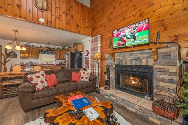 Fireplace and TV in the living room at Magic Moments, a 2 bedroom cabin rental located in Pigeon Forge