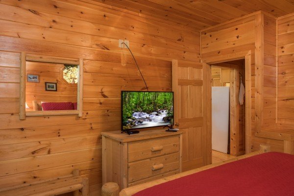Dresser and TV in a bedroom at Friends in High Places, a 4-bedroom cabin rental located in Pigeon Forge