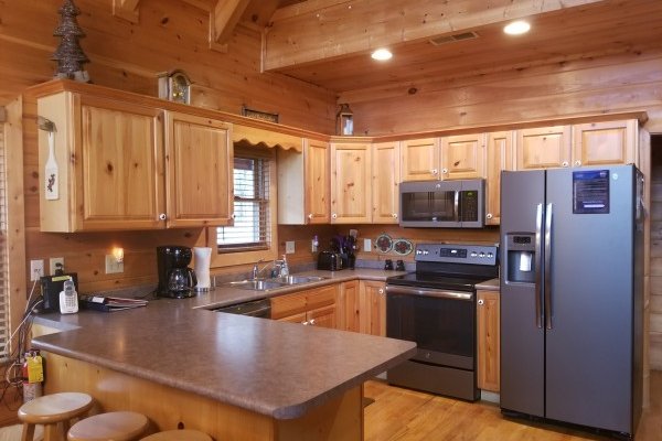 Kitchen with slate gray appliances at Friends in High Places, a 4-bedroom cabin rental located in Pigeon Forge