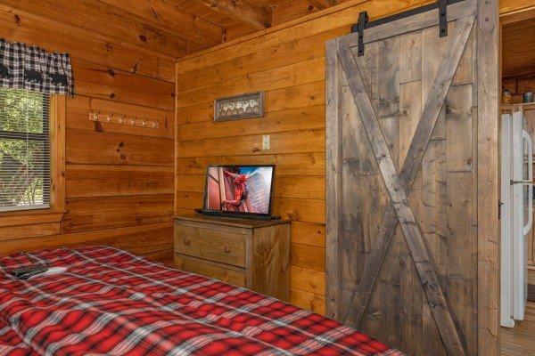 Dresser and TV in a bedroom at Honeymoon in Gatlinburg, a 1 bedroom cabin rental located in Gatlinburg