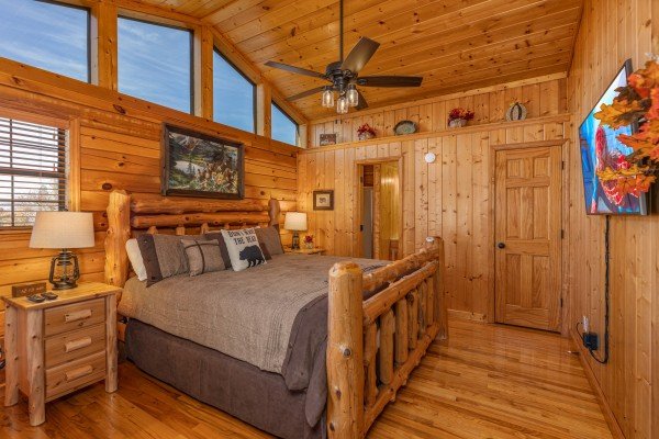 Bedroom with night stands, lamps, and TV at Close at Heart, a 1 bedroom cabin rental located in Pigeon Forge