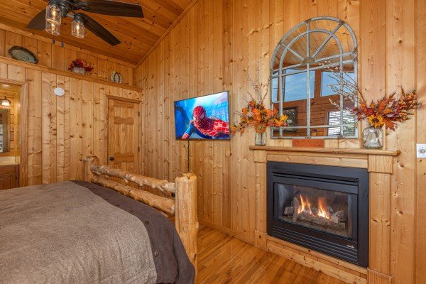 TV and fireplace in the bedroom at Close at Heart, a 1 bedroom cabin rental located in Pigeon Forge