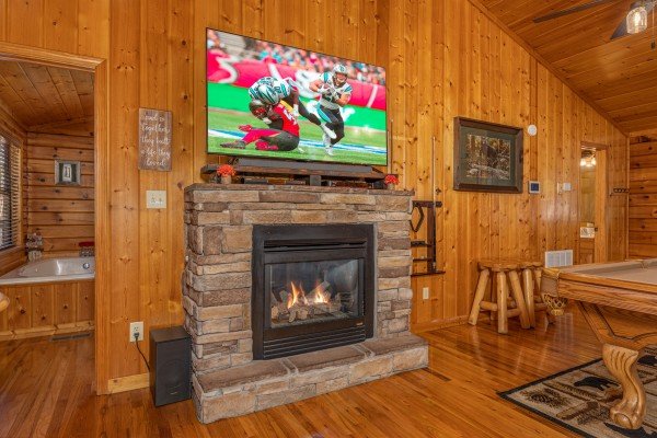 Fireplace and TV in a living room at Close at Heart, a 1 bedroom cabin rental located in Pigeon Forge