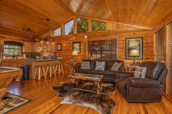 Living room, pool table, and kitchen at Close at Heart, a 1 bedroom cabin rental located in Pigeon Forge
