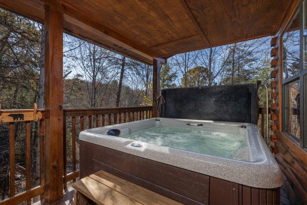 Hot tub on a covered deck at Close at Heart, a 1 bedroom cabin rental located in Pigeon Forge