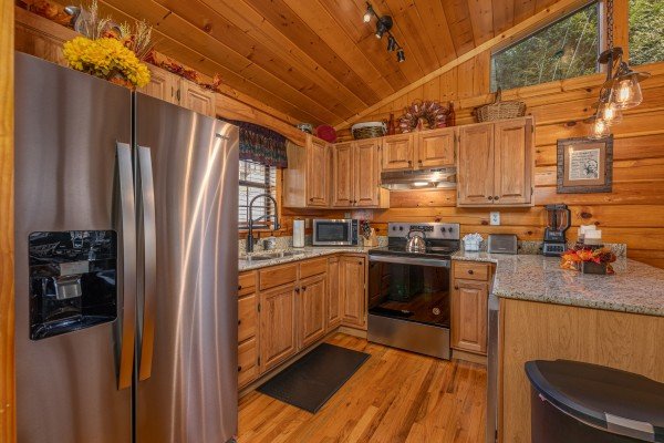 Kitchen with stainless appliances and granite counters at Close at Heart, a 1 bedroom cabin rental located in Pigeon Forge