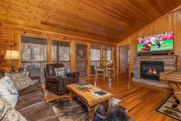 Living room with fireplace and TV at Close at Heart, a 1 bedroom cabin rental located in Pigeon Forge